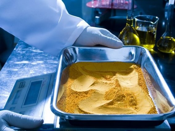 Yellowcake, concentrado de urânio em uma tigela sobre uma balança.